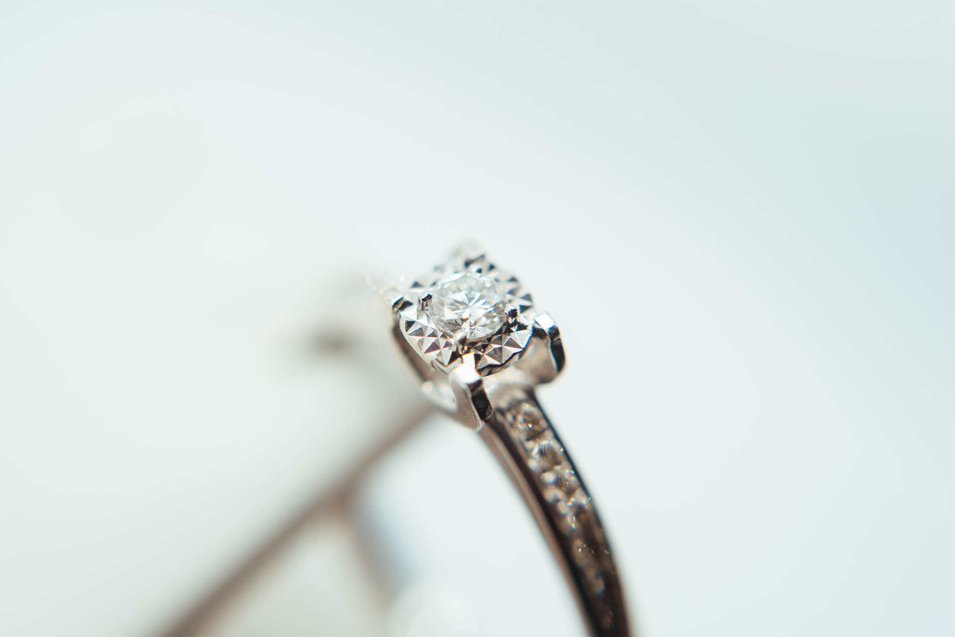 a white gold engagement ring with a round cut centre stone