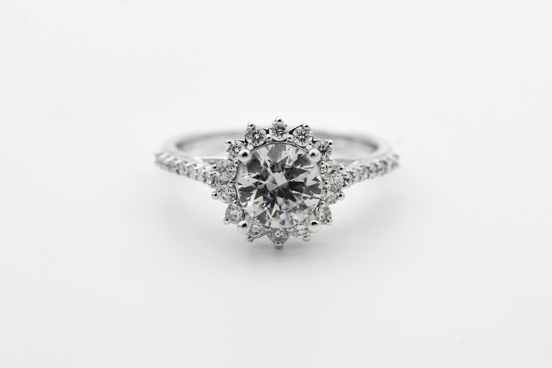 a white gold engagement ring with a floral diamond halo