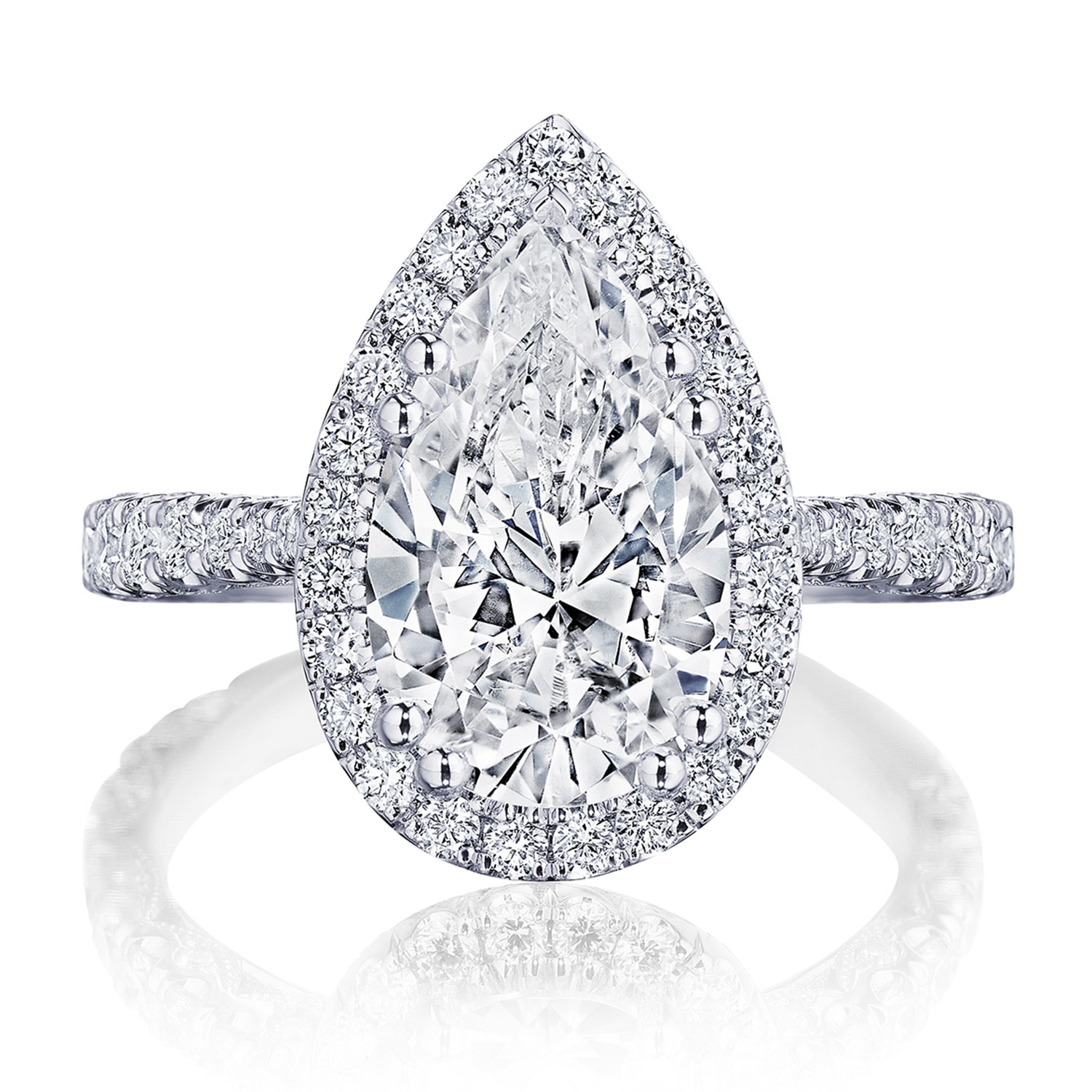A platinum pear shaped halo engagement ring with diamond encrusted band