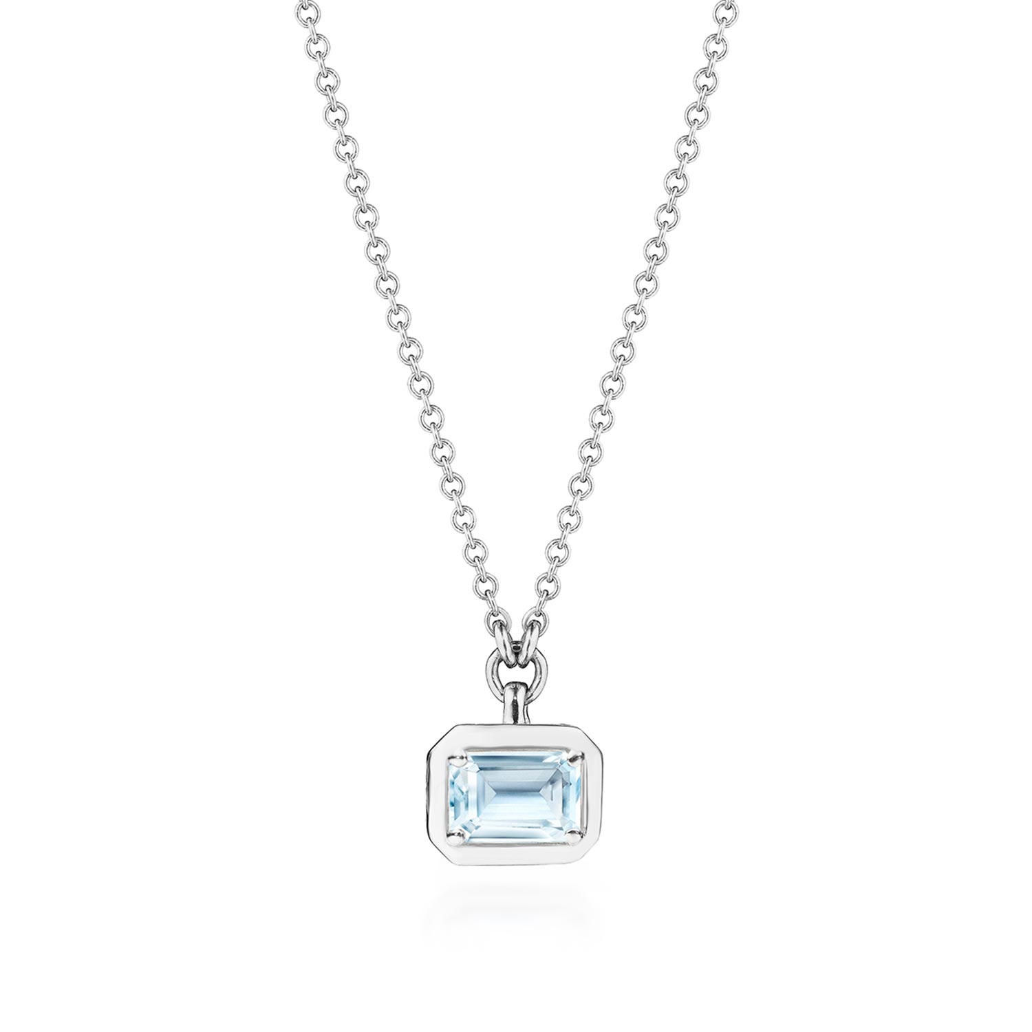 A white gold necklace pendant with emerald cut blue topaz.