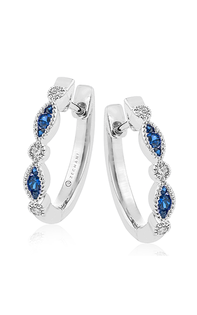 A white gold huggies with marquise cut sapphires against a white background