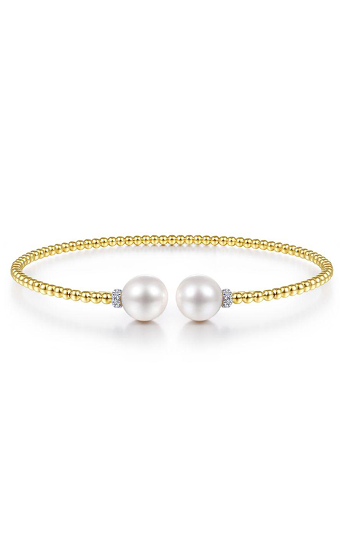 A yellow gold open cuff pear bracelet against a white background