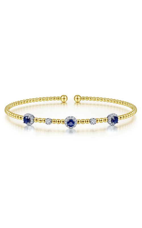A white and yellow gold cuff bracelet with gemstone accents
