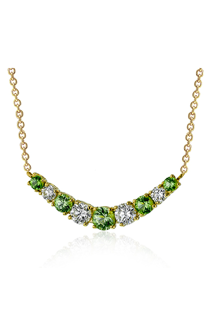 A yellow gold bar necklaces with diamonds and emeralds