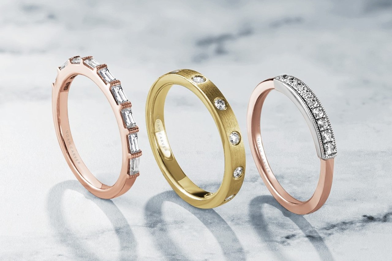 Three thin wedding bands set with differently cut diamonds