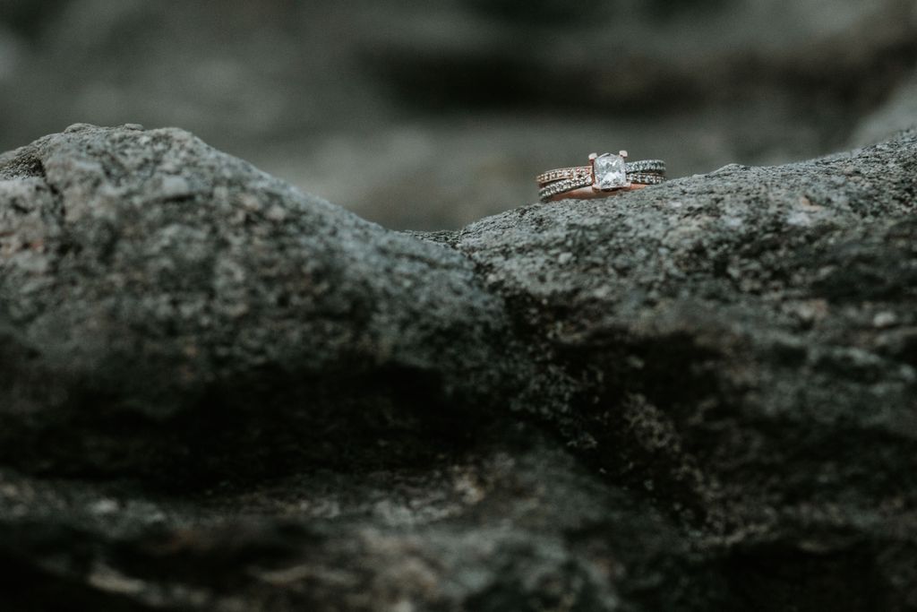 Princess cut ring with mixed metal band sitting on a band