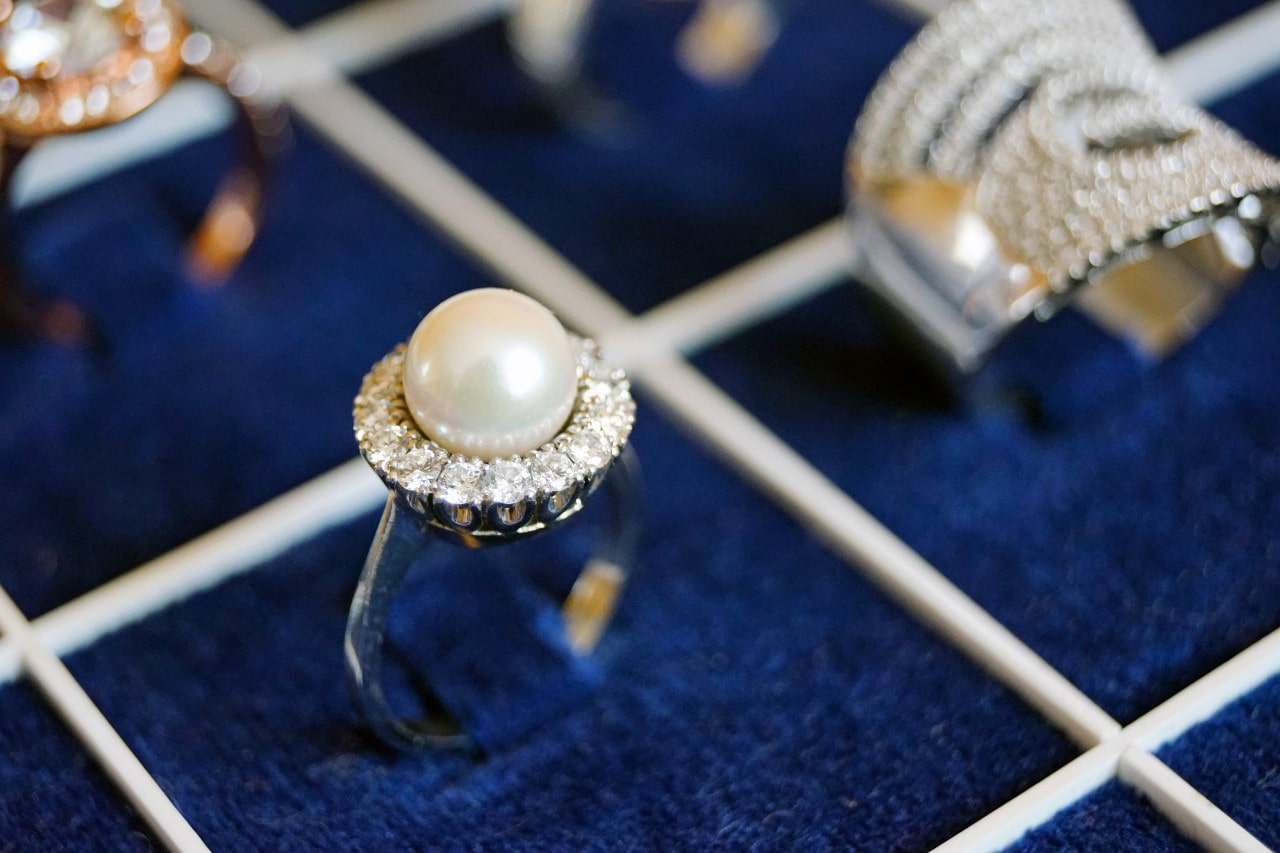 Fashion ring with pearl center stone and diamond halo setting