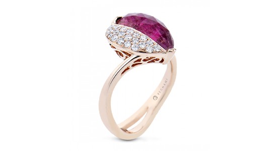 A rose gold ring featuring a large tourmaline and diamond accents