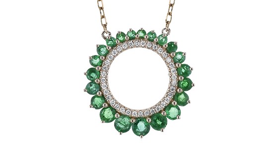 A circle pendant necklace with floral-inspired emerald details