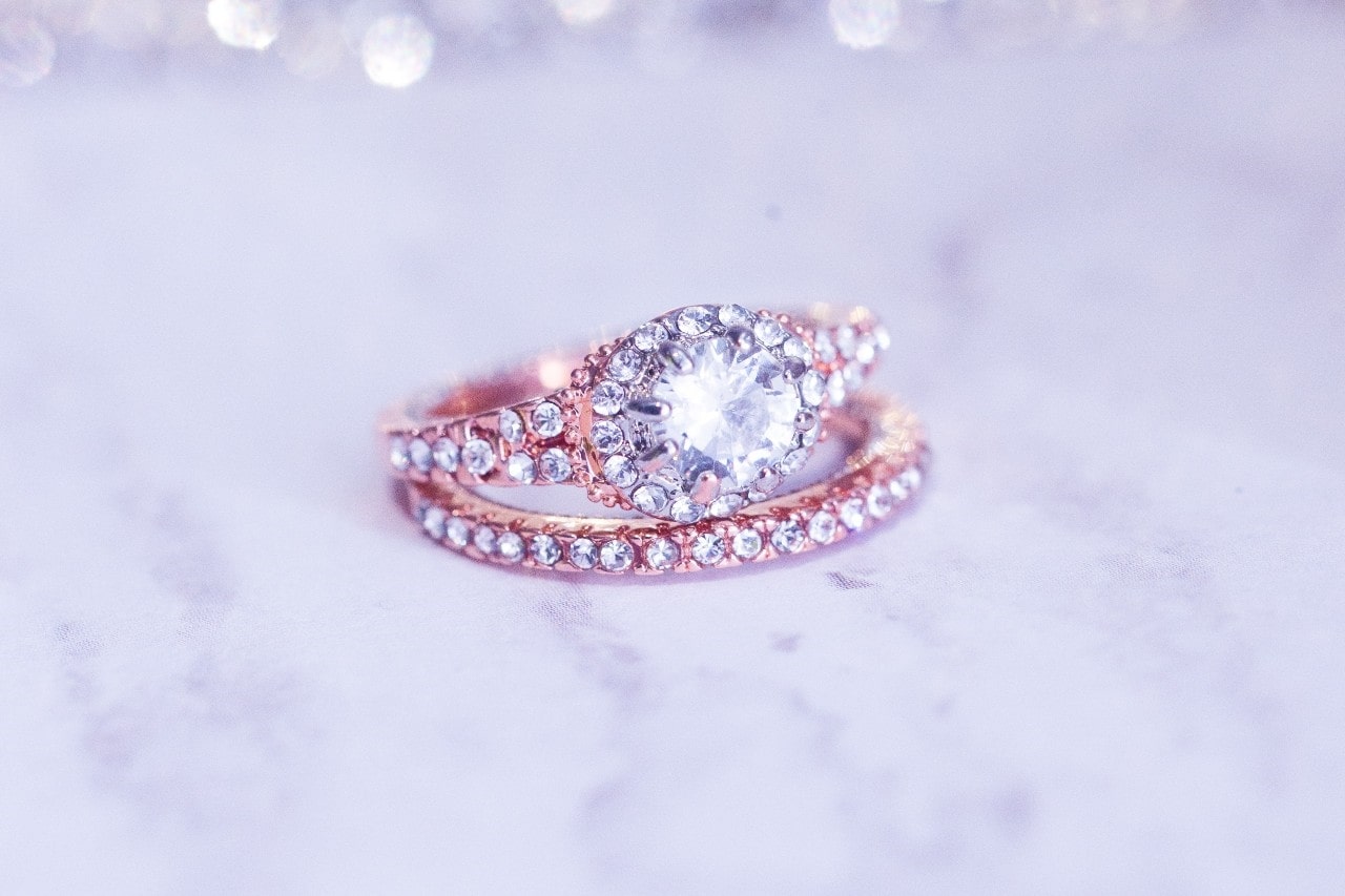 Two stacked rose gold and diamond engagement and wedding rings