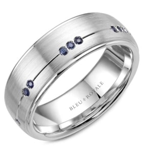 A men’s wedding band from Blue Royale features sapphire accents.