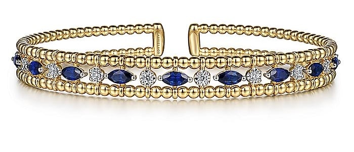 A gold cuff with sapphires and diamonds at Gabriel & Co.