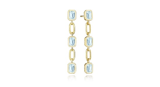 a pair of yellow gold drop earrings featuring bezel set blue topaz