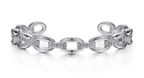 a white gold cuff bracelet that looks like a chunky chain with textured detail