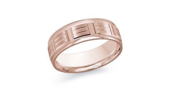 a rose gold men’s wedding band with carved details