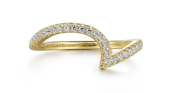 a yellow gold diamond wedding band with a curved silhouette