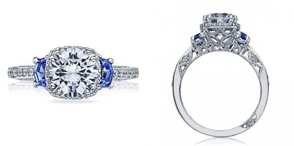 A cushion-cut diamond three stone engagement ring from Tacori’s Dantela collection features two sapphires and signature details